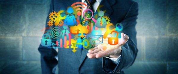 Manager Offering A Cloud Infrastructure Solution Man offering a cloud infrastructure solution made of a host of colorful managed services icons. Information technology concept for desktop virtualization, digital transition and MSP as facilitator.